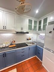 Modern kitchen with tiled backsplash and ample cabinetry