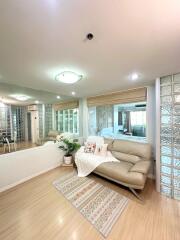 Modern living room with beige sofa and decorative pillows