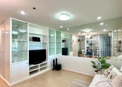 Modern living room with built-in shelves and TV