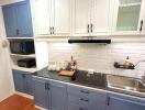 Modern kitchen with blue and white cabinetry