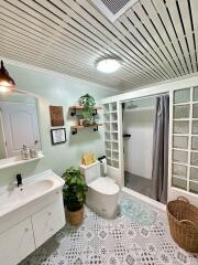 Bright bathroom with white fixtures and green accents