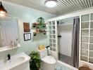 Bright bathroom with white fixtures and green accents