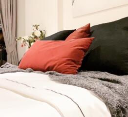 Cozy bedroom with decorative pillows and blankets