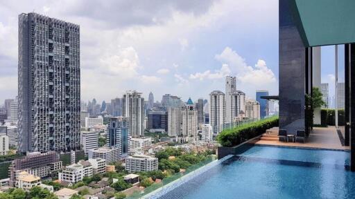 High-rise buildings and rooftop swimming pool with city skyline