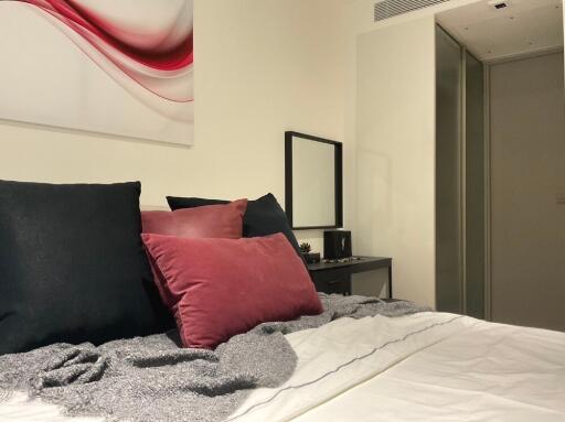 Modern bedroom with decorative pillows and artwork