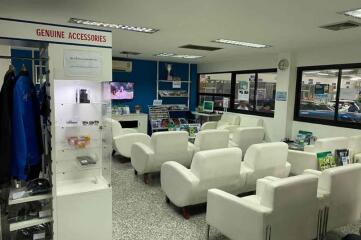 Modern waiting area with white chairs and various display items