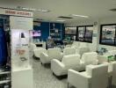 Modern waiting area with white chairs and various display items