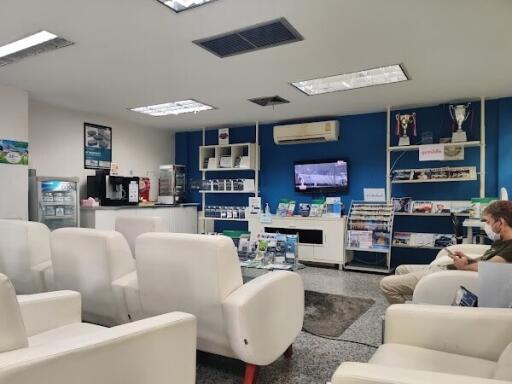 Modern living area with white seating and blue accent wall