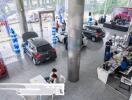 Car showroom with multiple vehicles and customer service areas