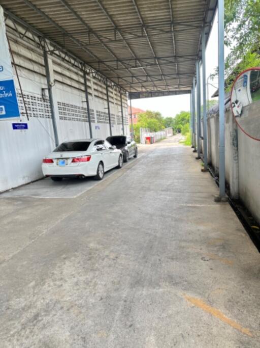 Covered parking area with two cars