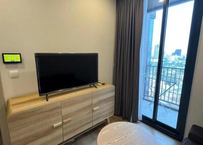 Modern living room with TV and balcony view