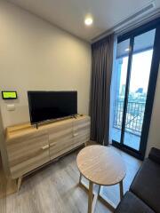 Modern living room with TV and balcony view