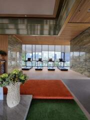 A modern gym with several treadmills facing large windows