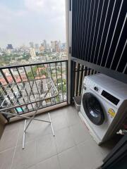 Balcony with washing machine and view of the city