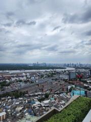 Aerial view of a cityscape with cloudy sky