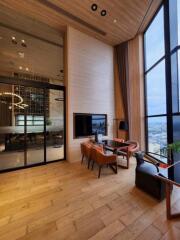 Modern living area with large windows and wooden floor