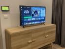 Modern living room with wooden TV cabinet and wall-mounted television