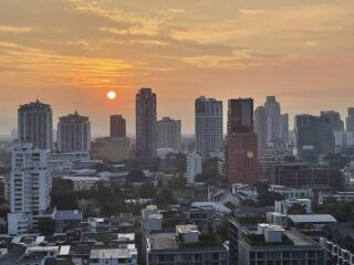 City skyline at sunset with various buildings