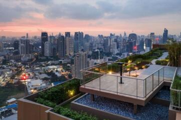 Rooftop terrace with city skyline at sunset