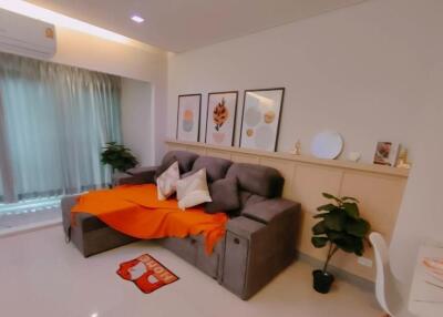 Modern living room with gray sofa and orange throw blanket