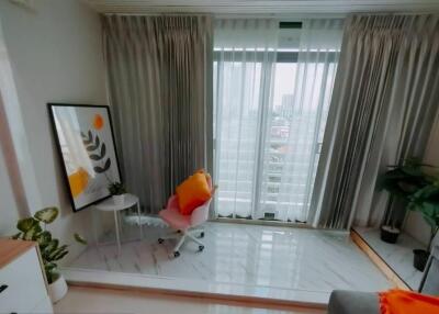 Cozy reading nook in living room with a chair and window