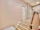 Staircase leading to upstairs hallway with white bench