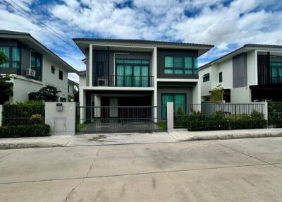 Modern two-story house with a fenced yard and a driveway