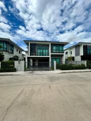 Modern two-story house with a fenced yard and a driveway