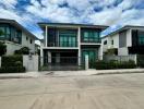 Modern two-story house with a fenced yard and a driveway