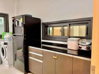 Modern kitchen with appliances and washing machine