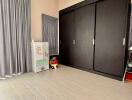 Children's bedroom with dark wooden wardrobe and toys