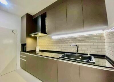 Modern kitchen with brown cabinets and subway tile backsplash