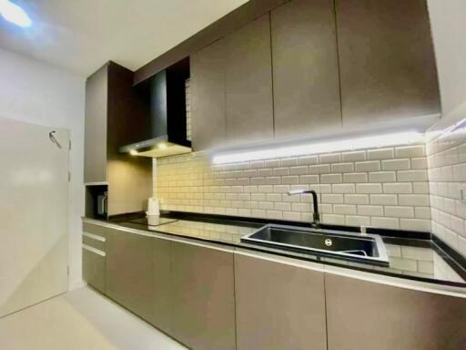 Modern kitchen with brown cabinets and subway tile backsplash