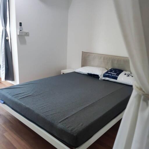 Bedroom with double bed, wooden flooring, and curtains