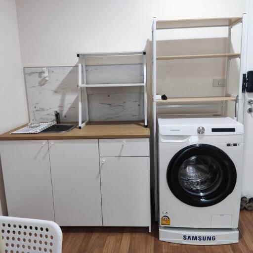 Laundry area with washing machine, sink, and shelves