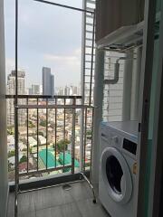 Laundry area with a washing machine and a city view