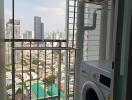 Laundry area with a washing machine and a city view