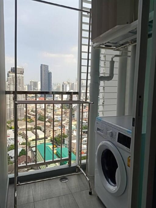 Laundry area with a washing machine and a city view