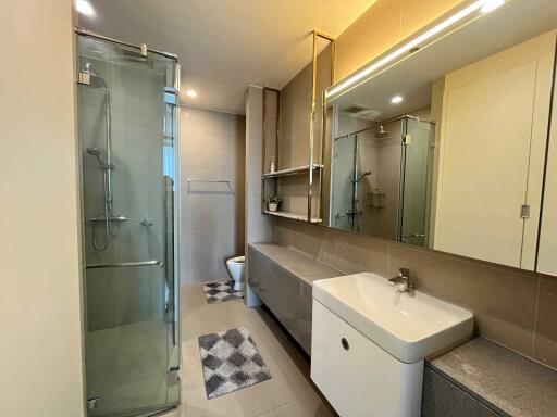 Modern bathroom with glass shower and large mirror