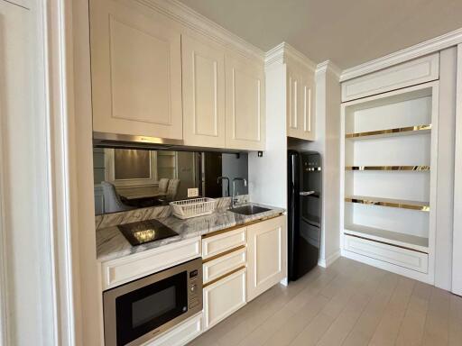 Modern kitchen with built-in appliances and marble countertop