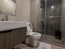 Modern bathroom with sink, toilet, and glass shower