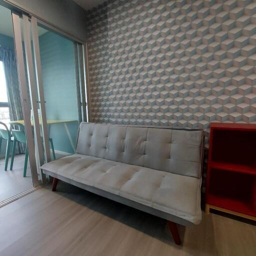 Modern living room with geometric wallpaper and sofa