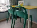 Small table with two chairs near a window in a room