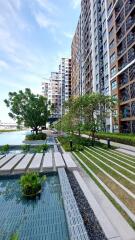 Modern apartment complex with garden and water features