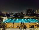 Night view of swimming pool with city skyline in the background