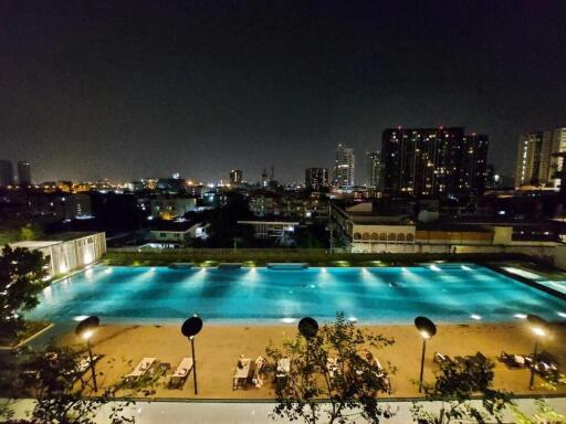 Night view of swimming pool with city skyline in the background