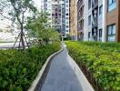 Walkway next to high-rise buildings with greenery