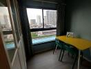 Small dining area with a window view and yellow table