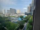 View from building exterior with garden and other high-rise buildings