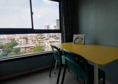 room with window view and yellow table